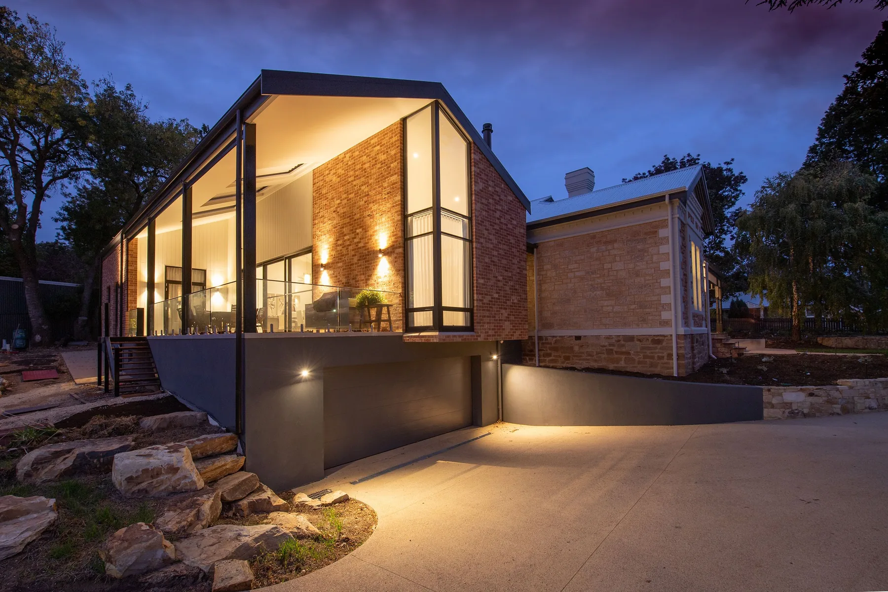 A newly built brick and render home photographed at dusk